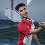 a man playing badminton