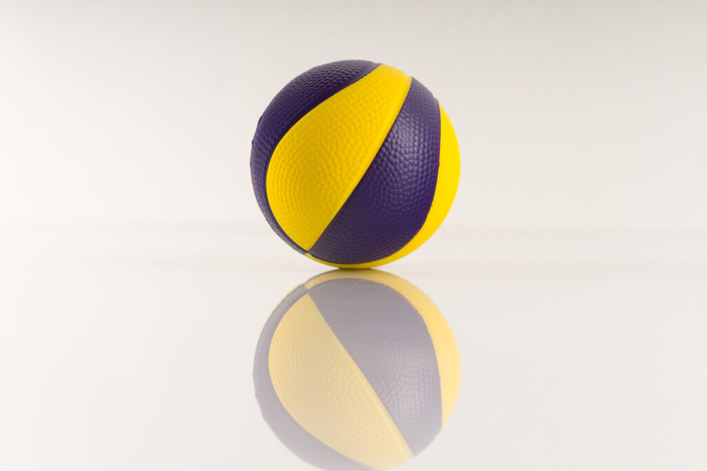 Basketball ball with yellow and purple spots on a white background. Antistress ball